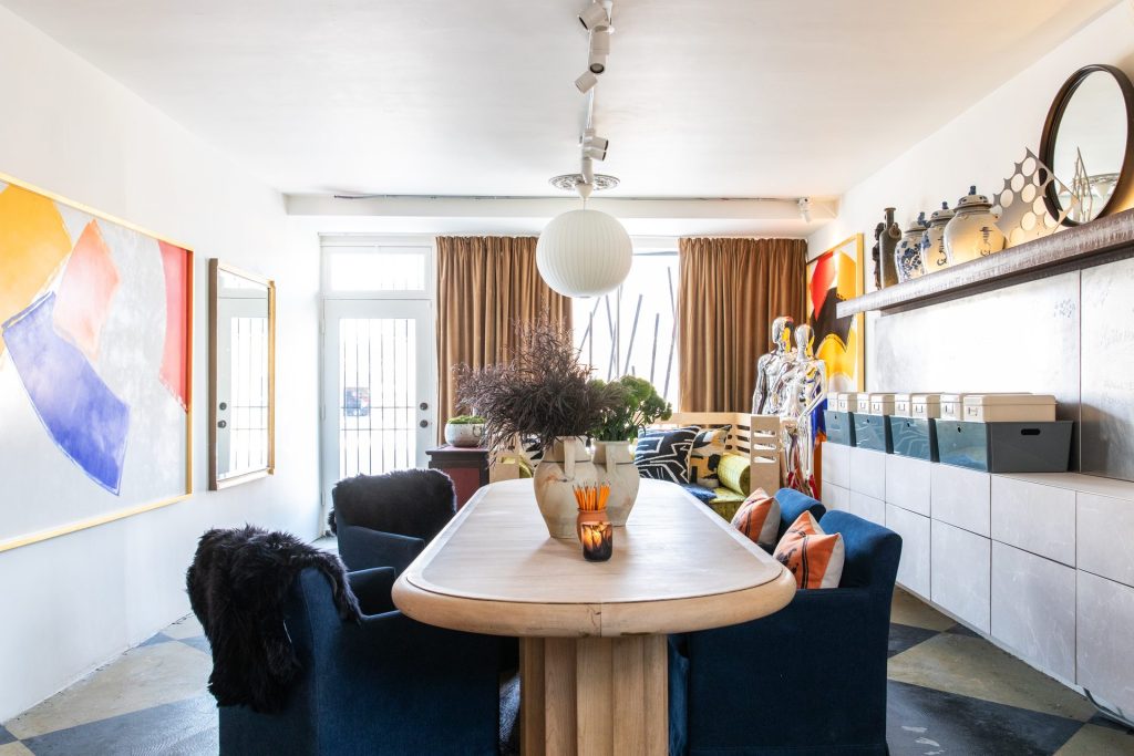 Modern interior design in a luxury Las Vegas living room with abstract artwork, walnut dining table, and curated decor — FredricAlexander.